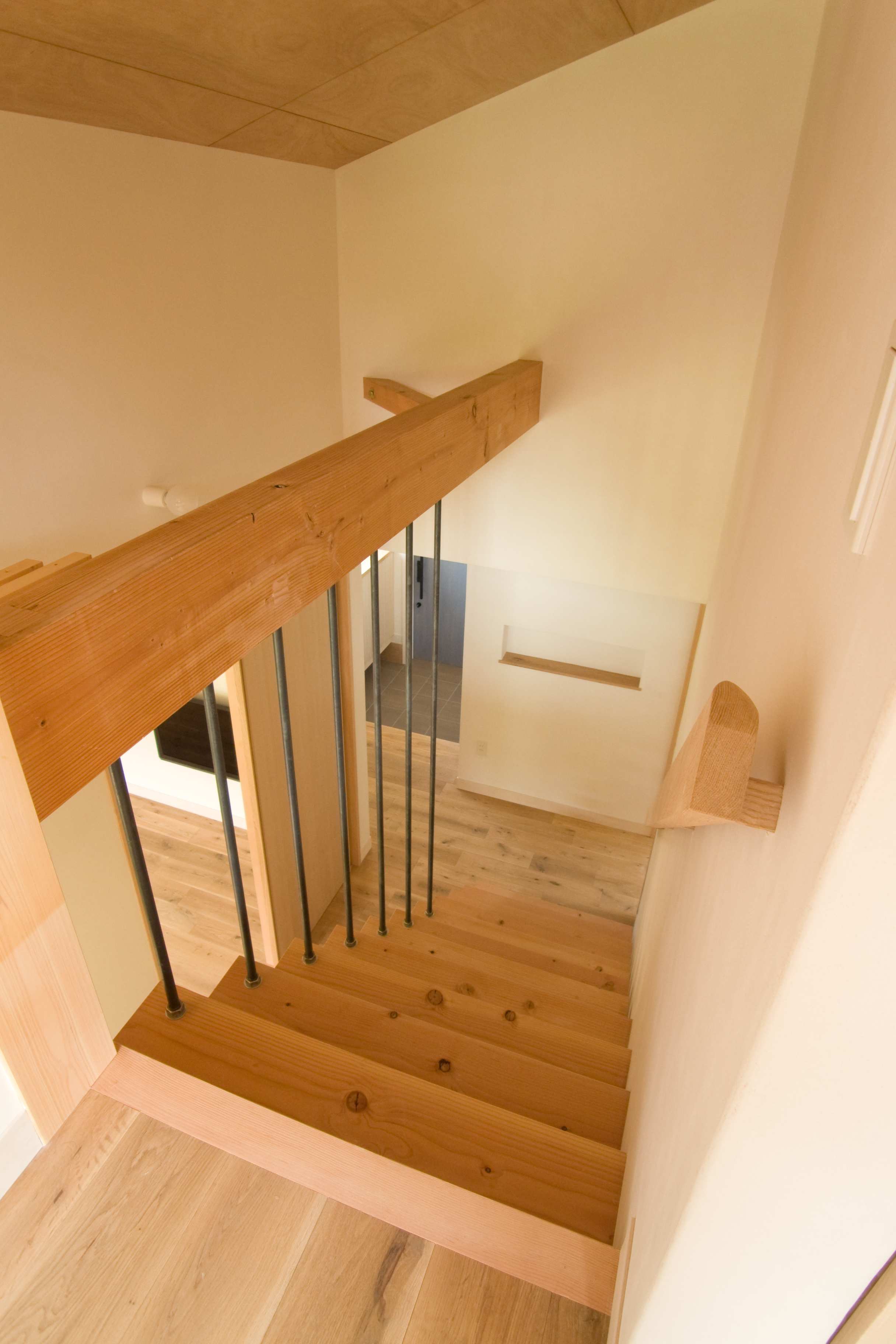 階段ホールを見下ろす＿赤松の踏板、オーク厚板の無垢フローリング