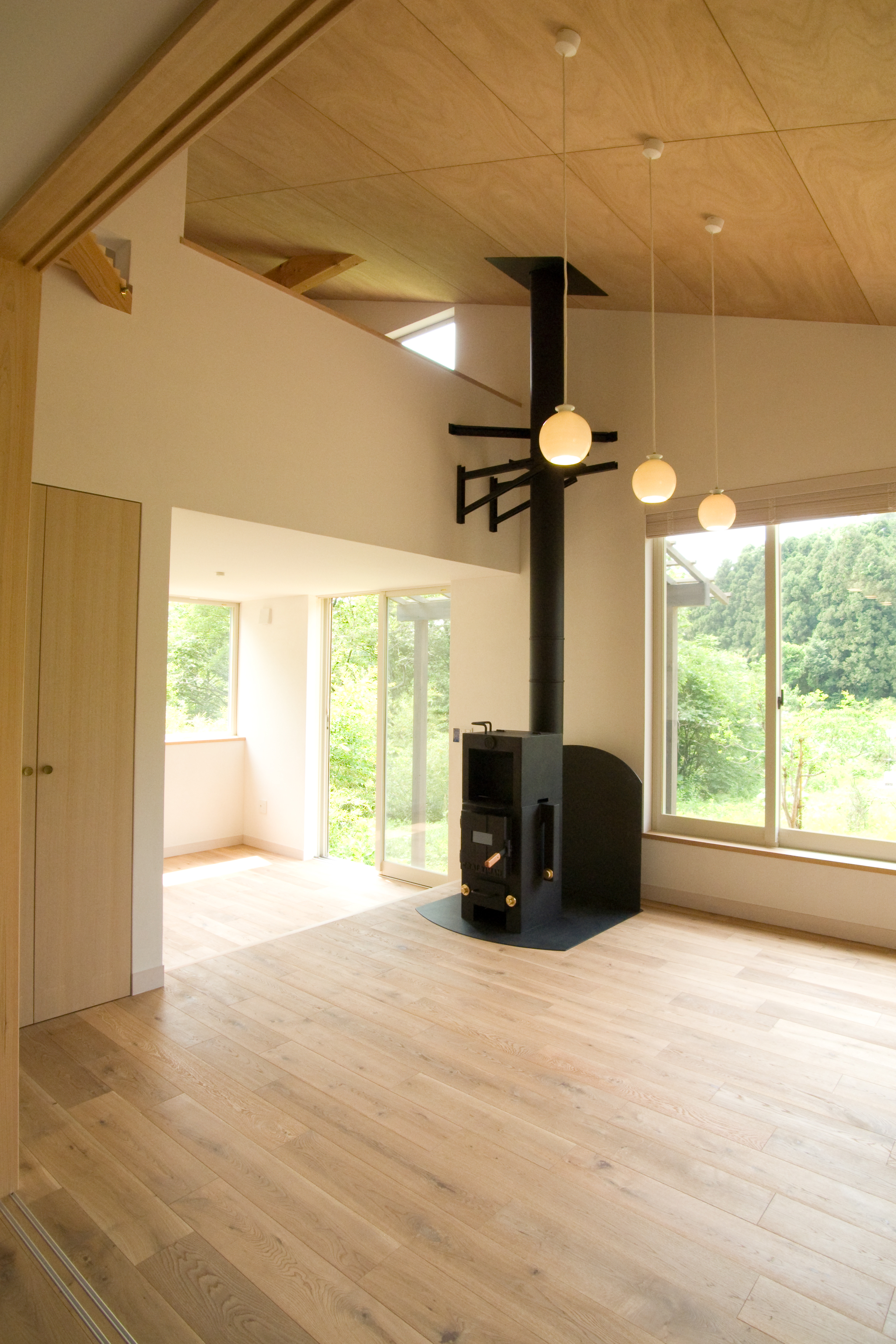 リビングからダイニング方向＿薪＆ペレット兼用ストーブを設置＿ダイニング床は300下がり空間を緩やかに分離